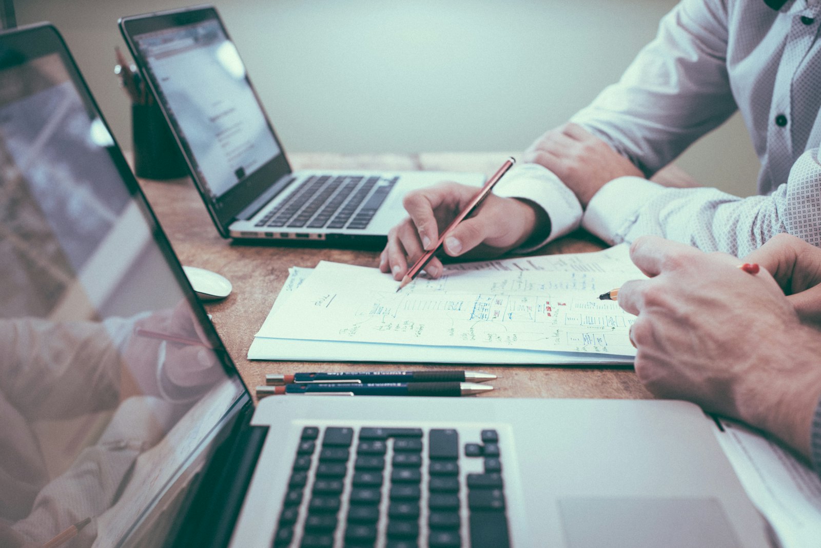 Advisors reviewing financial documents at a desk